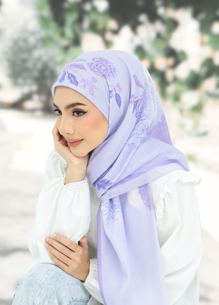 Model Wearing Printed Cotton Scarf Sit Down 3/4 Front View With Outdoor Background