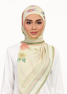 Model wearing printed botanical floral design tudung bawal in daisy yellow