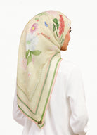 Model wearing printed botanical floral tudung cotton voile in daisy yellow