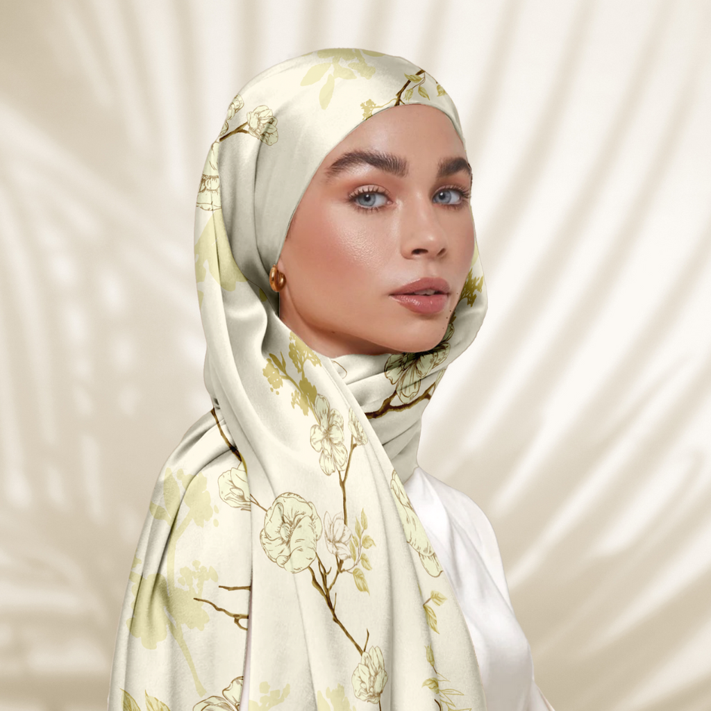 Model Wearing Printed Satin Tudung 3/4 View With Leaf Shadow Background