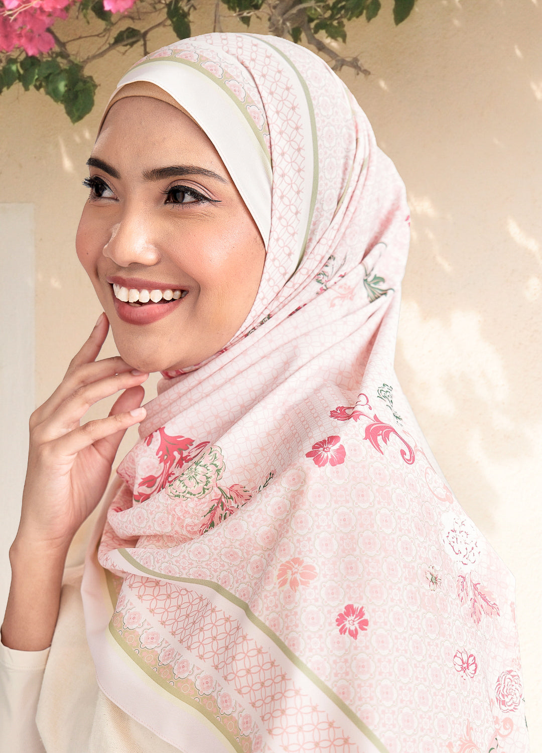 Woman wearing a floral hijab with a light background
