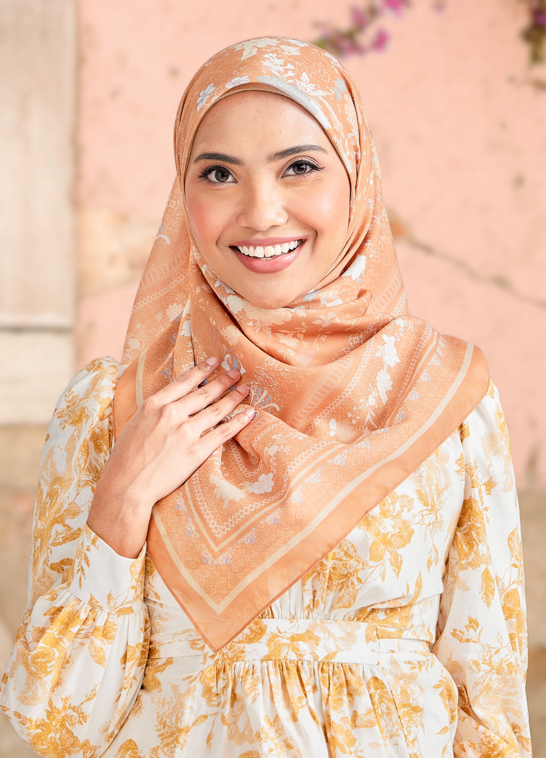 Women wearing floral hijab in sand gold color with blurred background