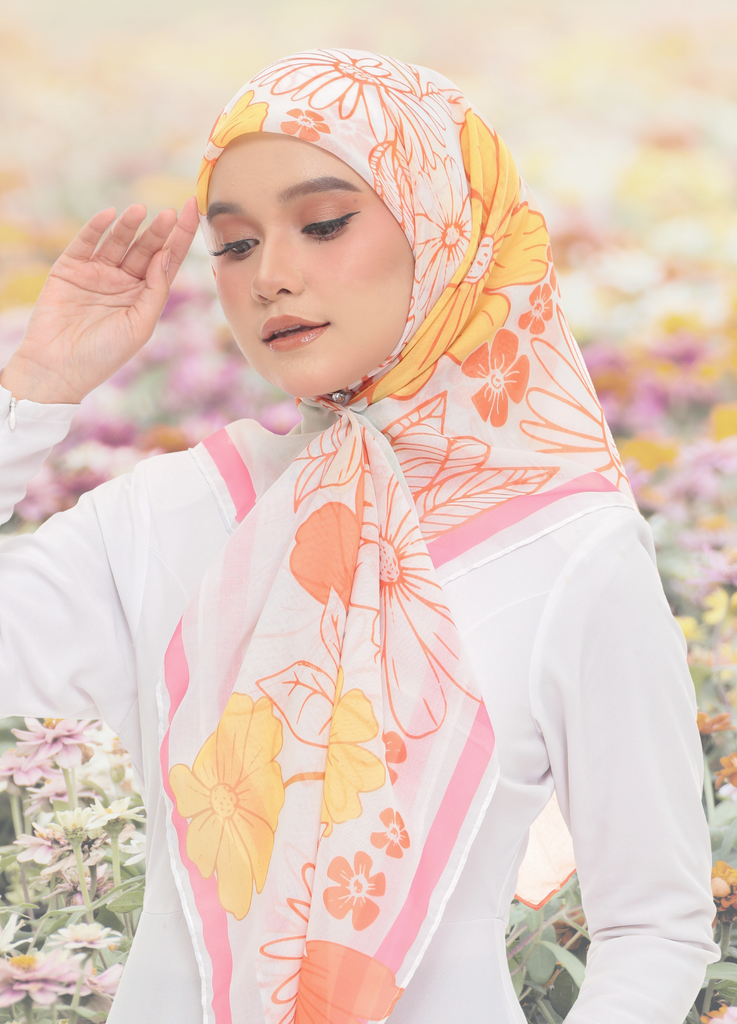 Model Wearing Printed Cotton Scarf 3/4 View With Flower Background