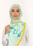 Model wearing printed intricate floral cotton voile tudung bawal - light green