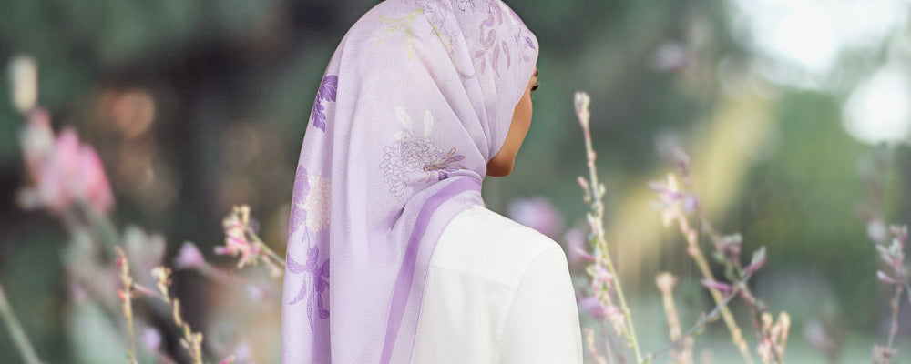 Model wearing printed floral cotton tudung bawal purple