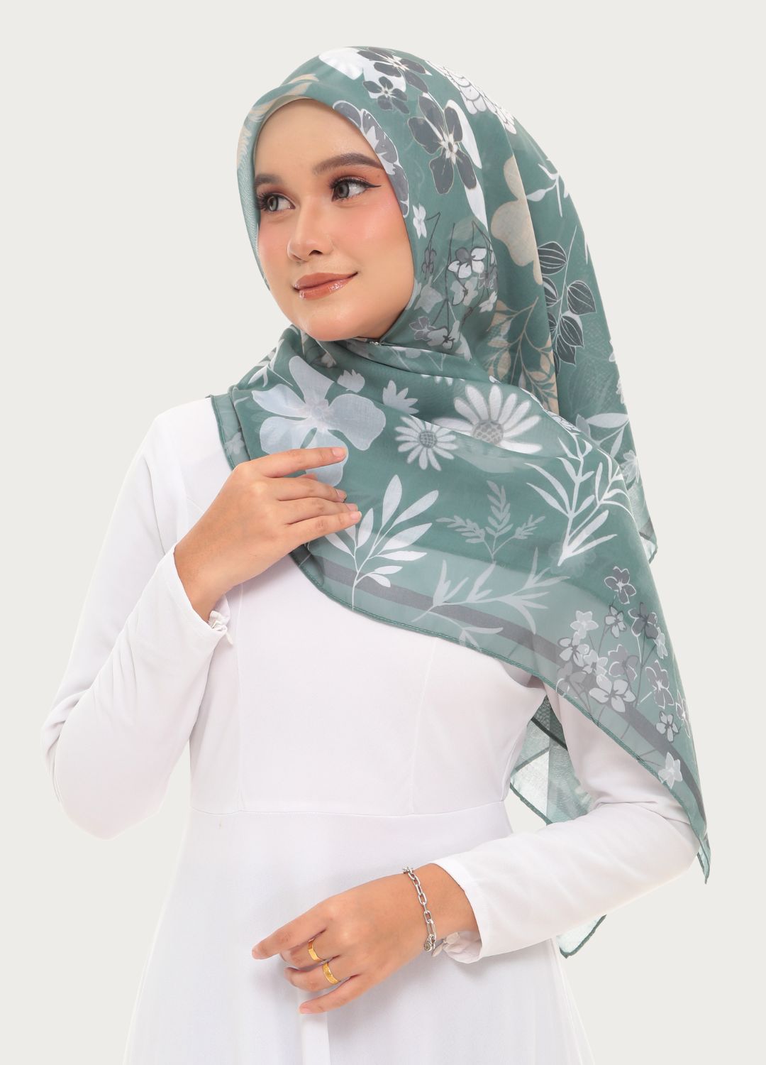 Model wearing Printed Cotton tudung bawal dark green plain background