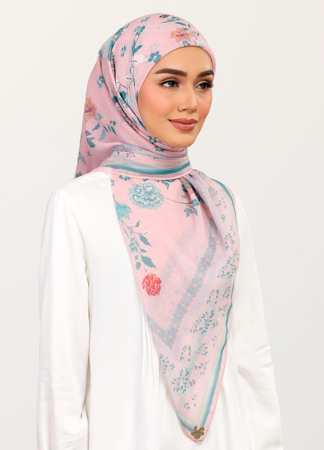 Model wearing printed stylized floral tudung bawal cotton in dusty pink