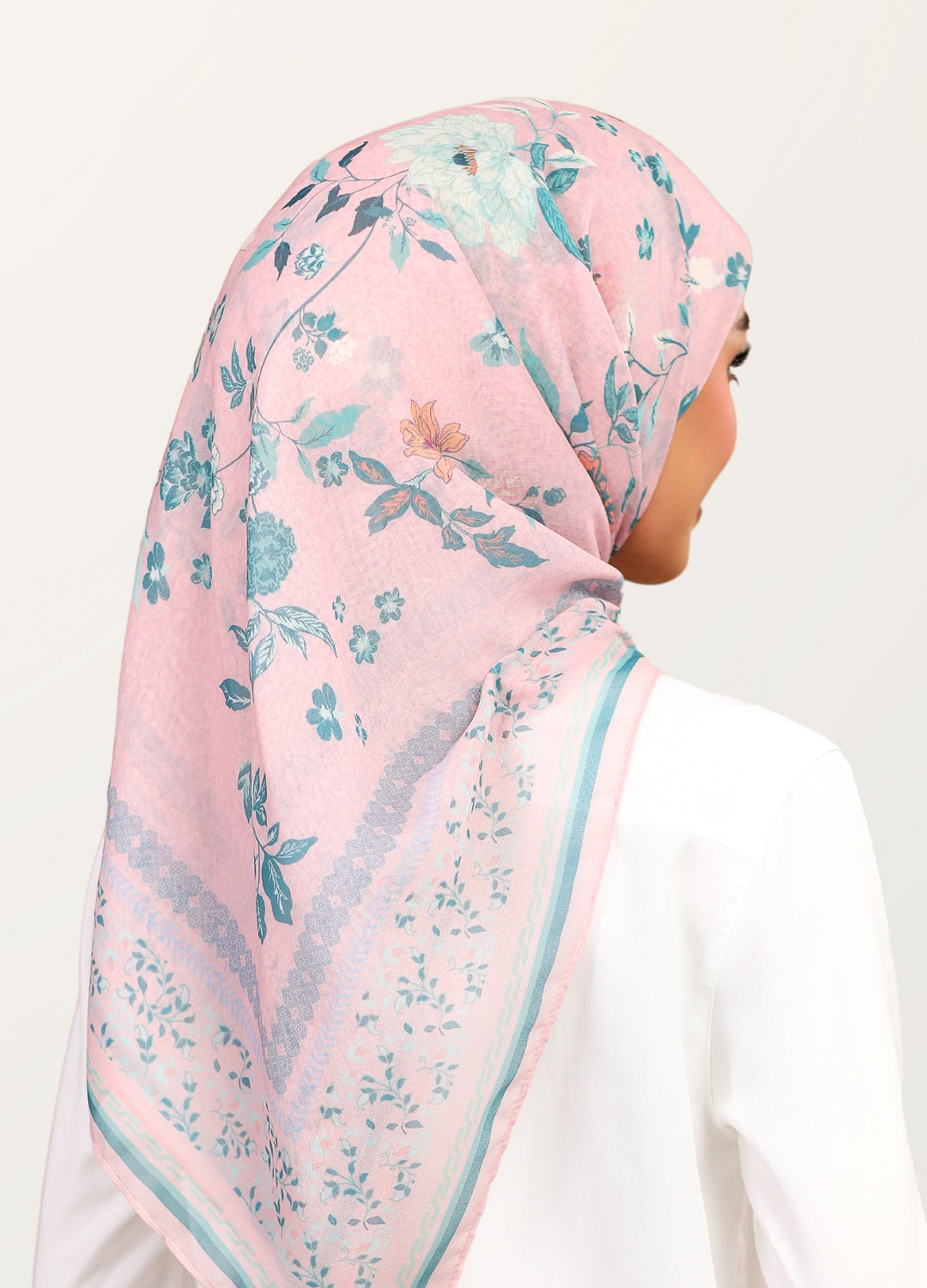 Model wearing printed stylized floral tudung bawal - dusty pink