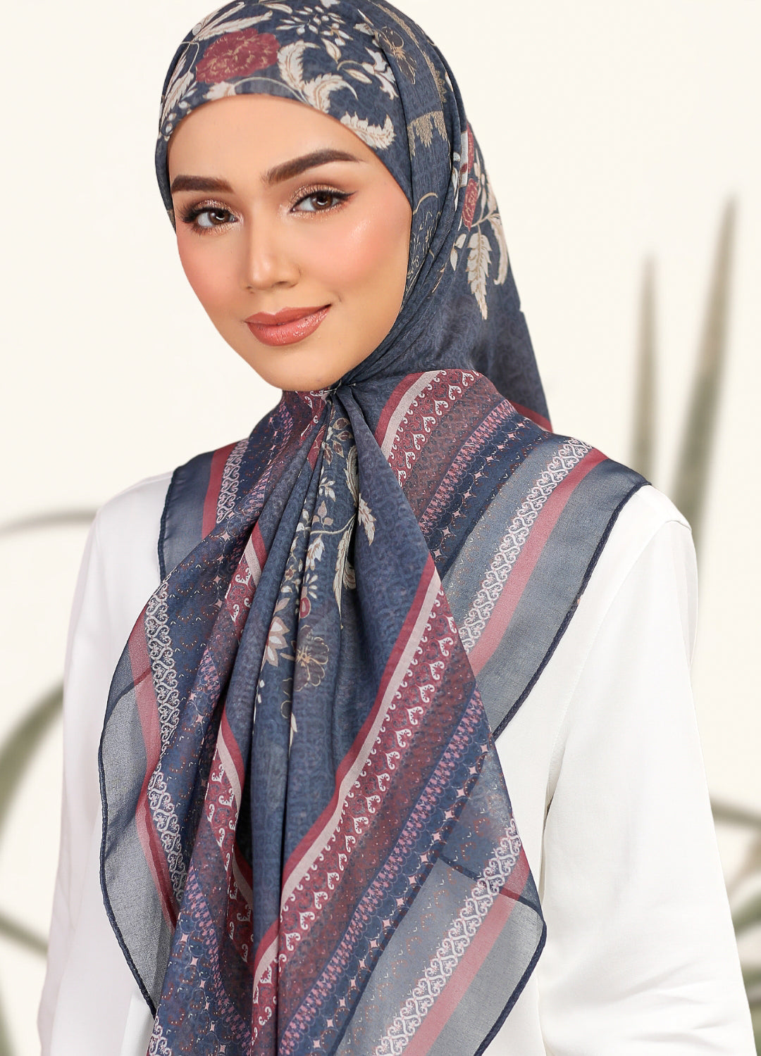 Model wearing Printed ornamental floral design cotton tudung bawal in dark navy