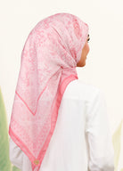 Model wearing printed filligree floral cotton tudung bawal in salmon pink