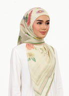 Model wearing printed botanical floral design tudung cotton in daisy yellow