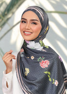 Model wearing printed botanical floral silk satin shaw tudung - black