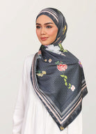 Model wearing printed botanical floral satin tudung shawl - black