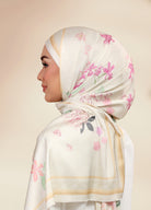 Model wearing printed floral shawl satin silk tudung in beige