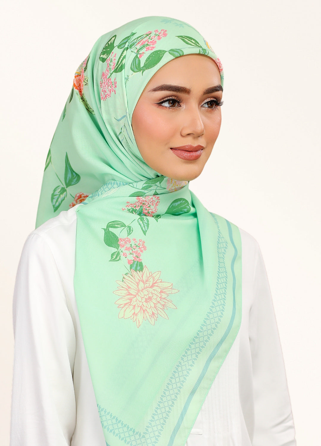 Model wearing printed hand drawn botanical floral cotton tudung bawal - green