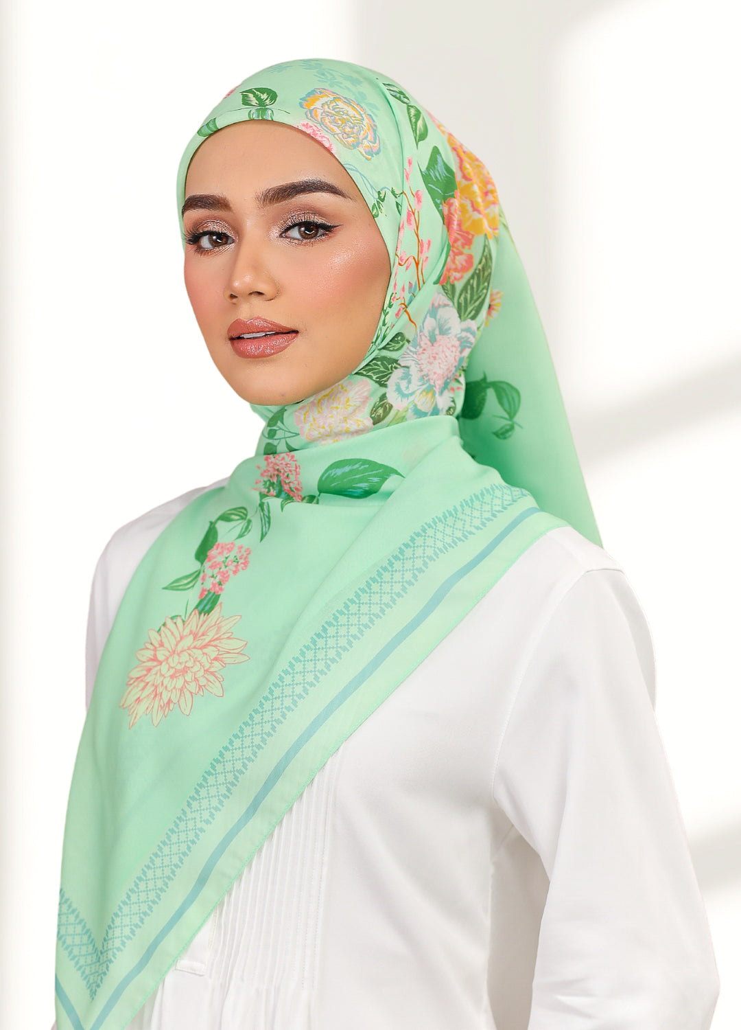 Model wearing printed hand drawn botanical floral cotton voile tudung - Green