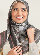 Woman wearing a floral hijab with a neutral background