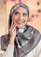 Woman wearing a floral hijab with a blurred floral background