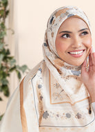 Woman wearing a floral hijab with a neutral background