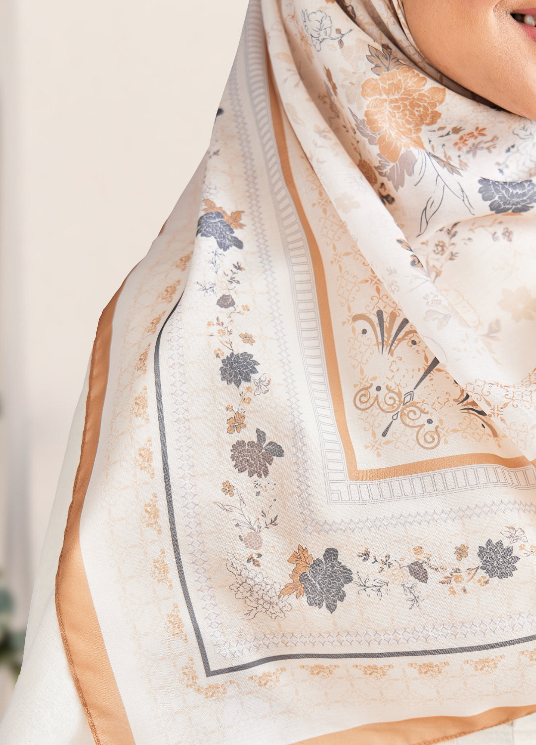 Close-up of a floral patterned scarf with a neutral background