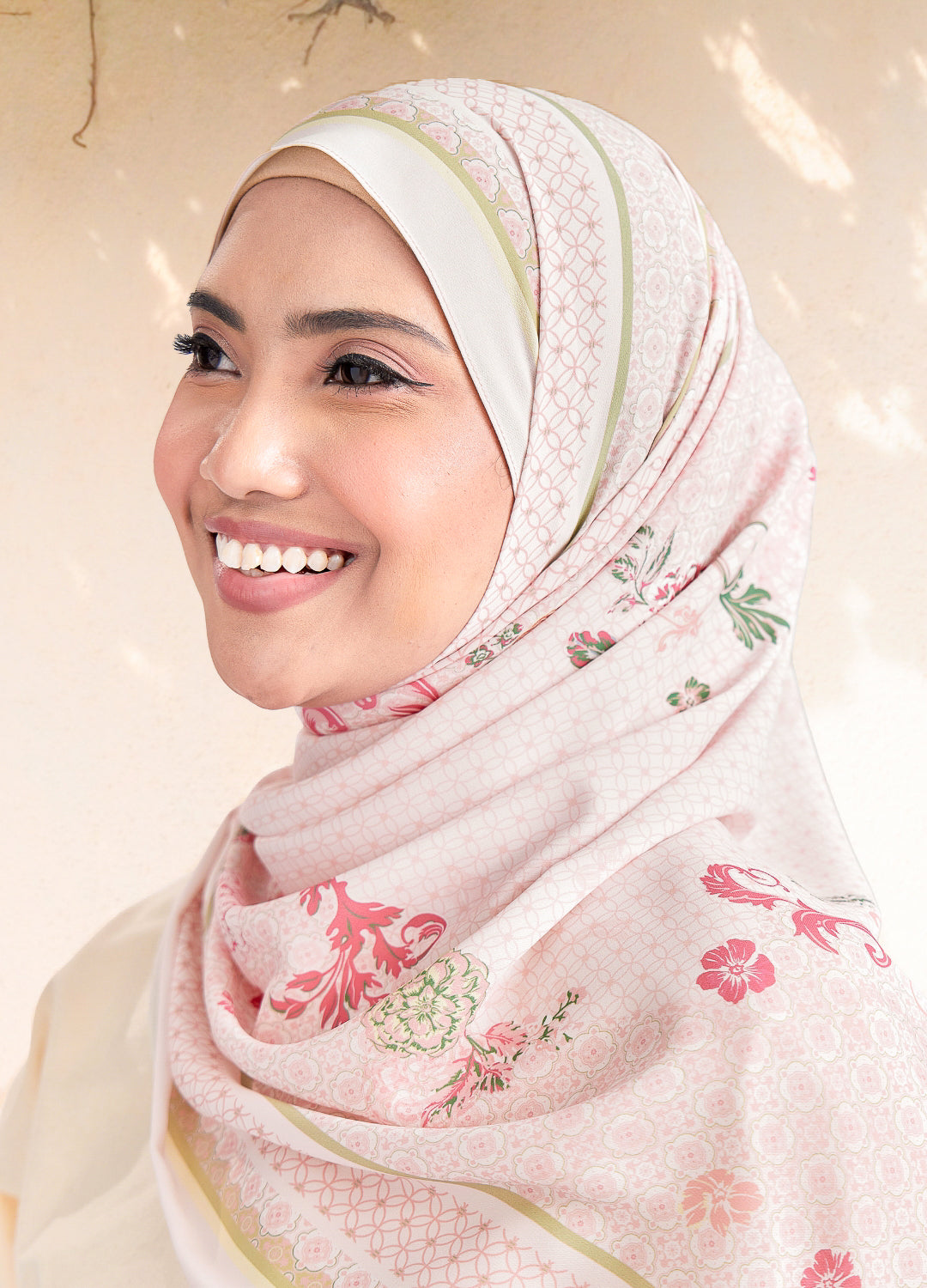 Woman wearing a floral hijab with a soft background