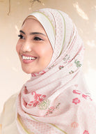 Woman wearing a floral hijab with a soft background