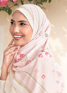 Woman wearing a floral hijab with a light background