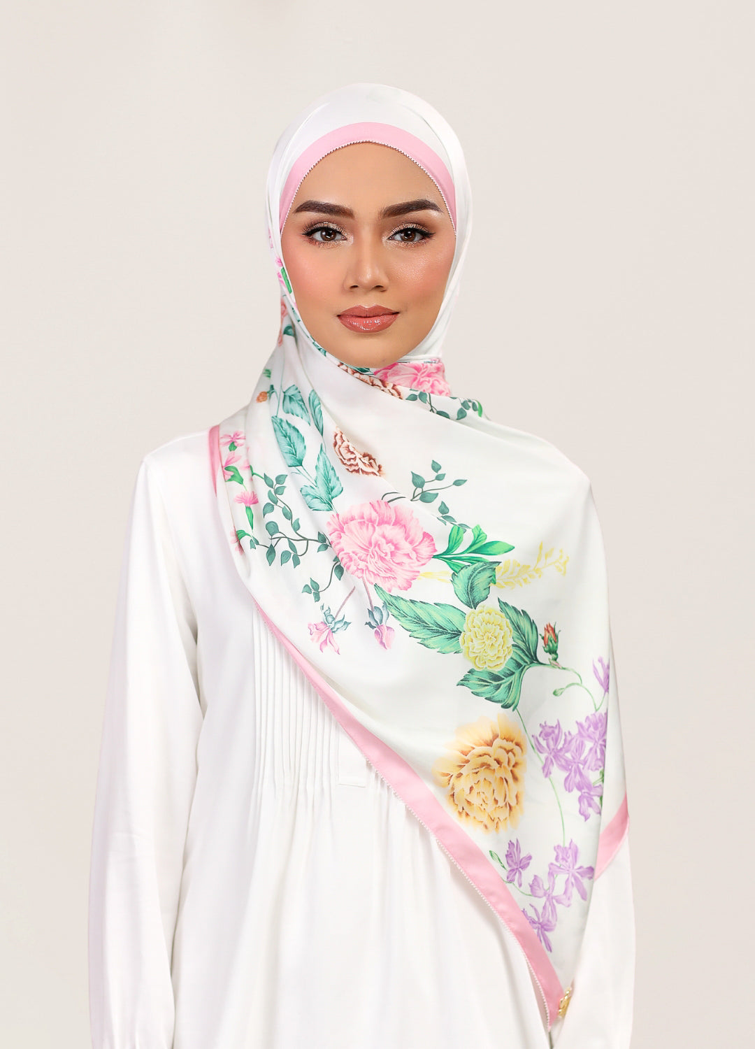 Model wearing printed botanical floral satin shawl tudung - white