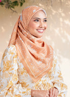 Women wearing sand gold color hijab with blurred outdoor background