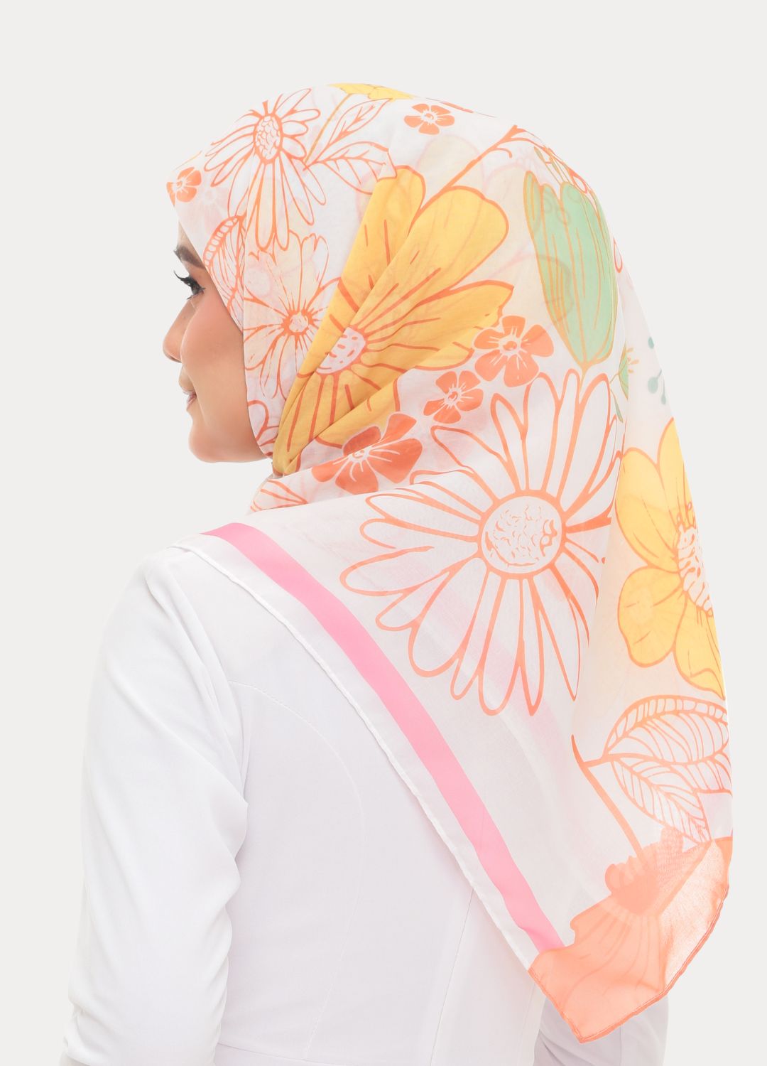 Model wearing printed fun floral cotton tudung bawal bright colors