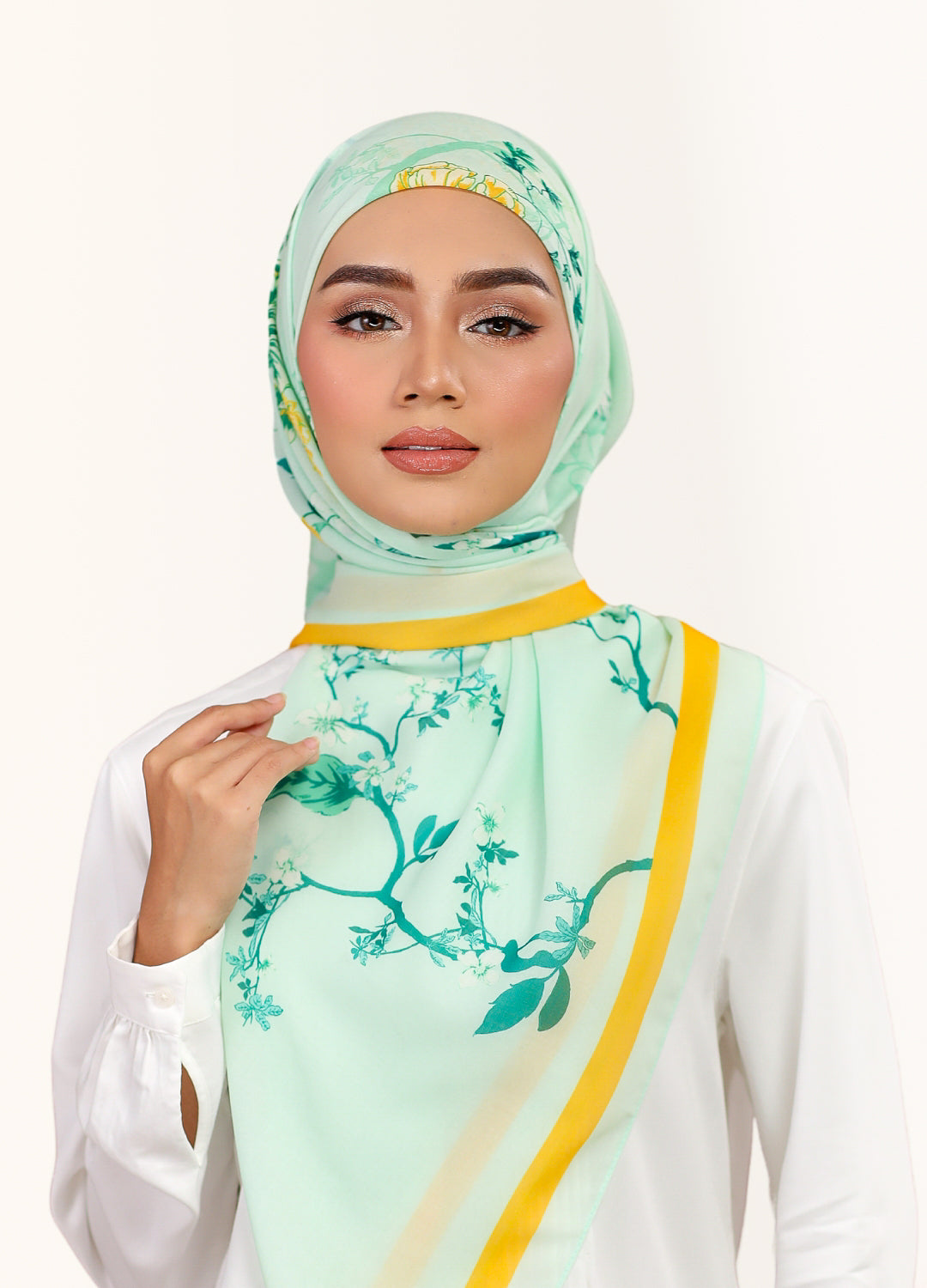 Model wearing printed intricate floral cotton voile tudung bawal - light green