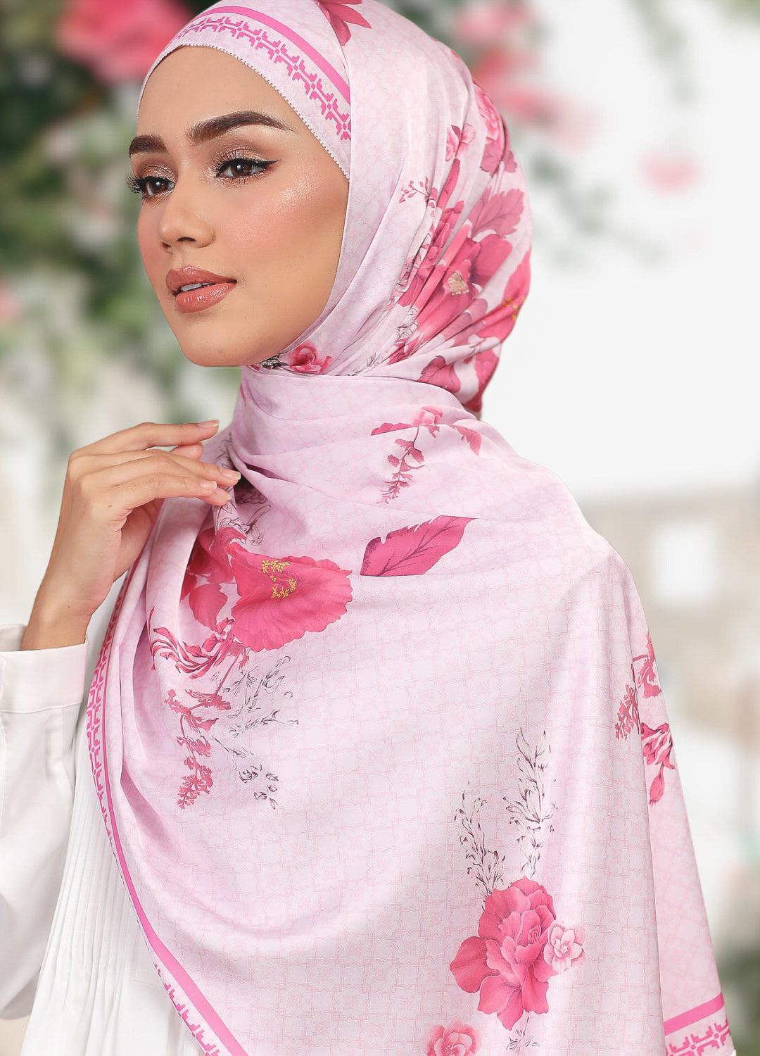 Model wearing printed floral satin shawl tudung - light pink